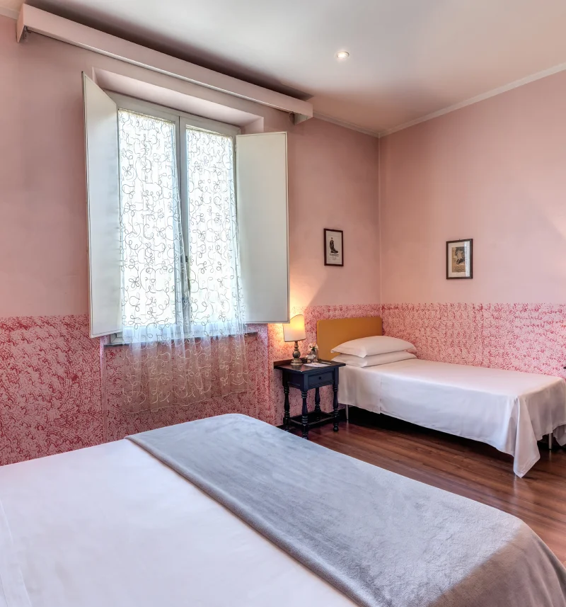 Triple room with double bed, single bed, pink walls, wooden floor and bright window - Hotel Rex, BZAR hotels in Lucca
